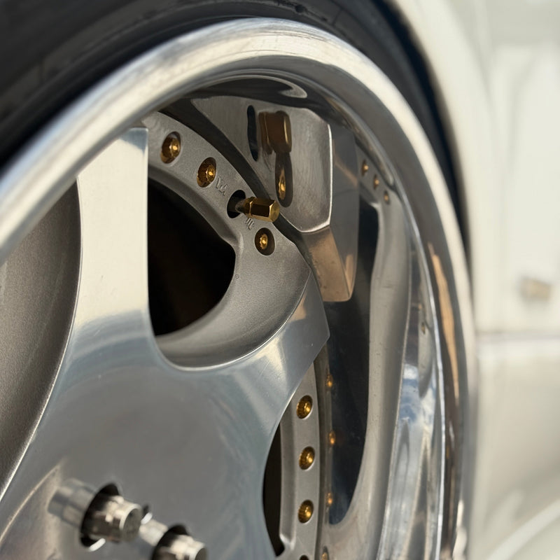 Load image into Gallery viewer, Gold Valve Caps on Weds Kranzes, focus action shot
